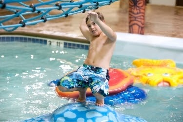 Kid playing in an indoor pool