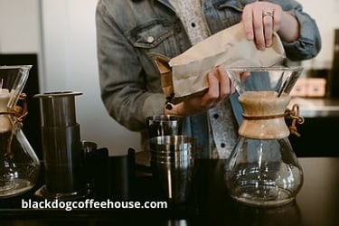 Man adding coffee beans to a cup