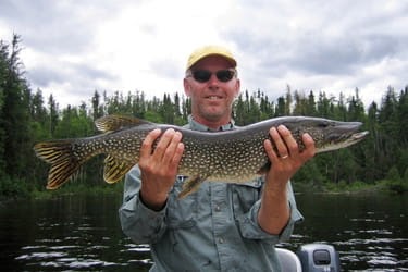 Man holding a northern pike