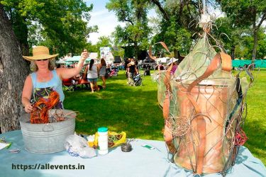 Woman making art with a garbage can