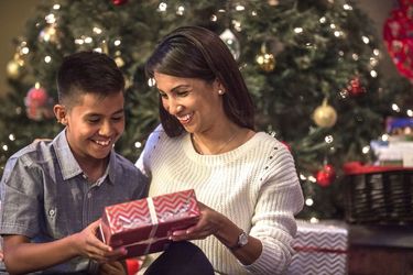 Woman giving a gift to a kid