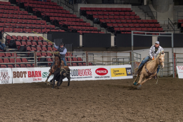Two men riding horses