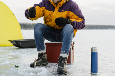 Person pulling a fish from the frozen lake