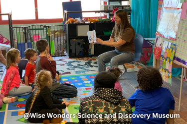 Teacher showing a book to her class